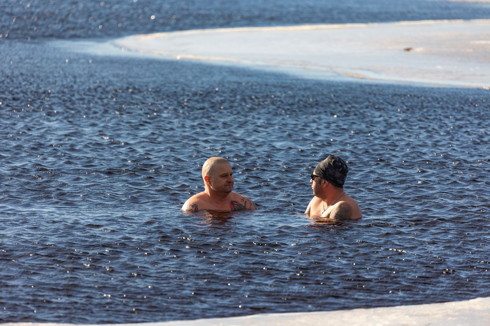 Two people immersed in icy cold water