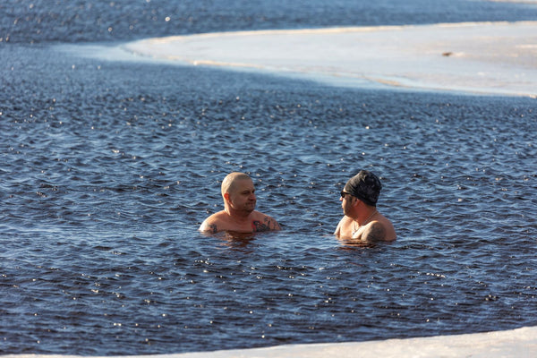 Two people immersed in icy cold water