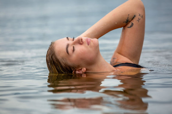A person swimming calmly in cool open water