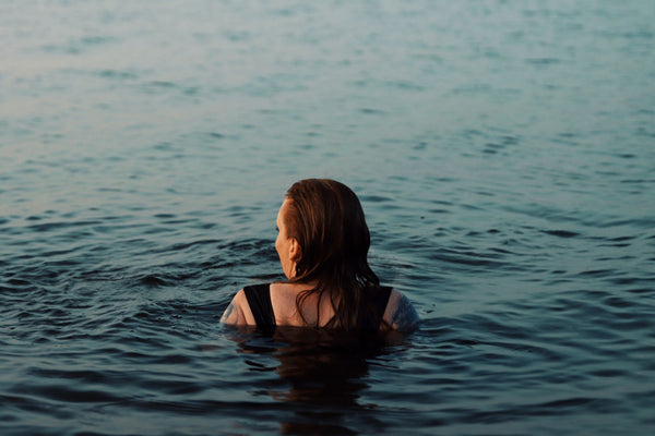 A woman swimming serenely in a cold northern lake