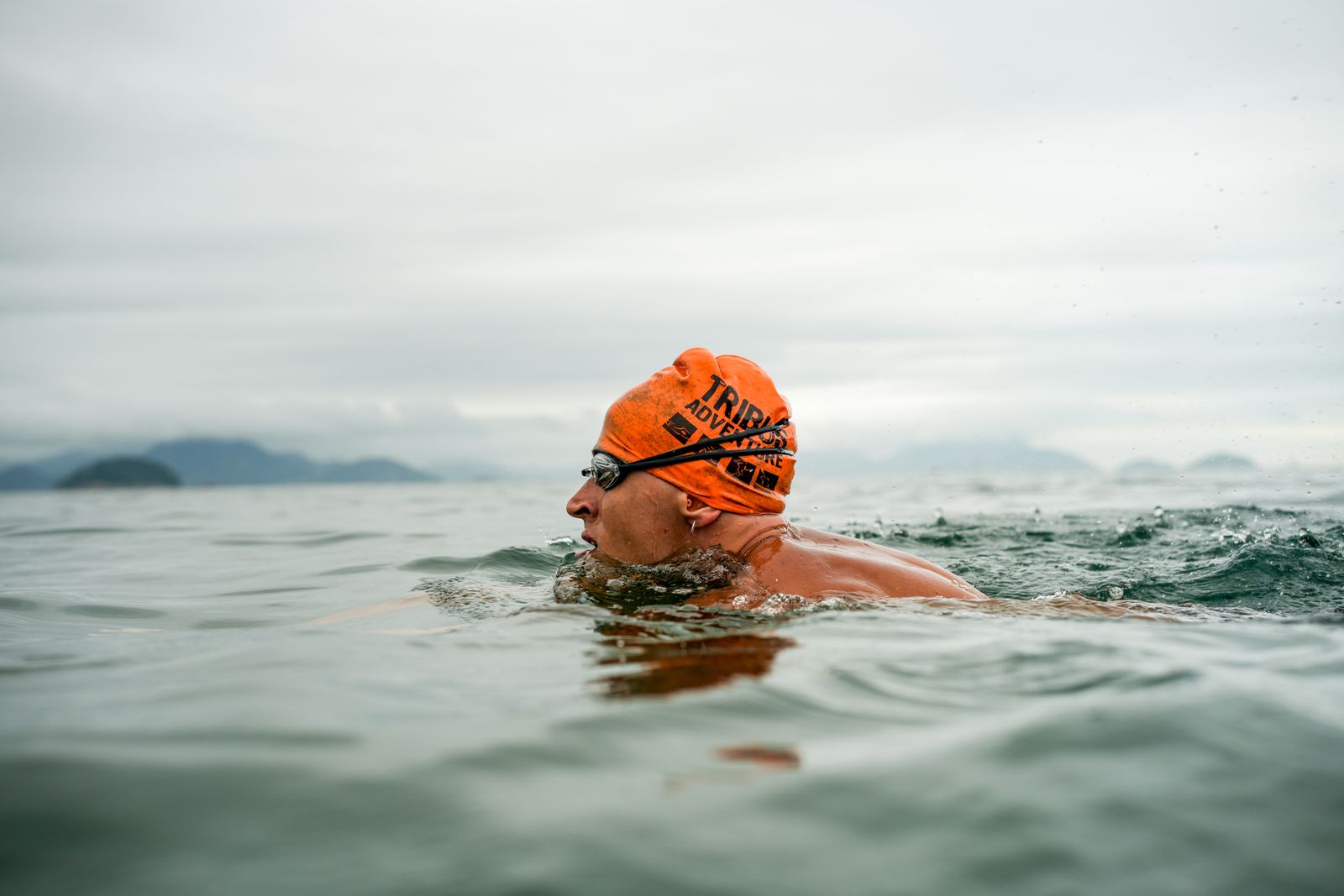 An athletic swimmer in cold open water